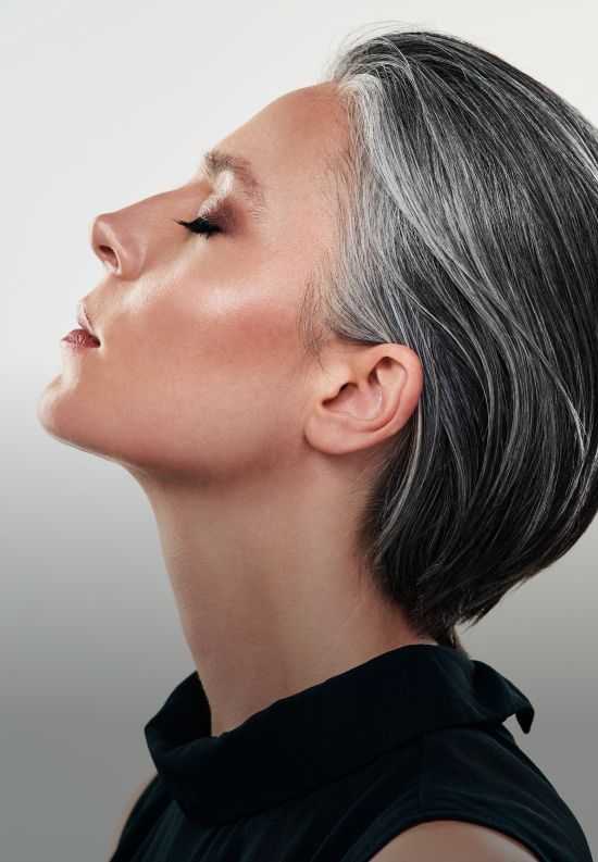Profile portrait of a woman with silver hair.