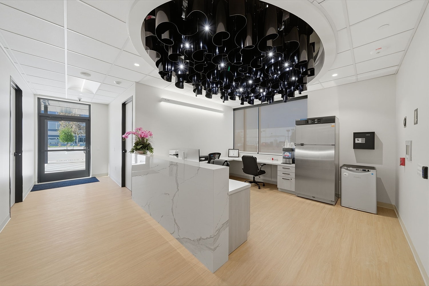 Modern office reception area with stylish lighting.