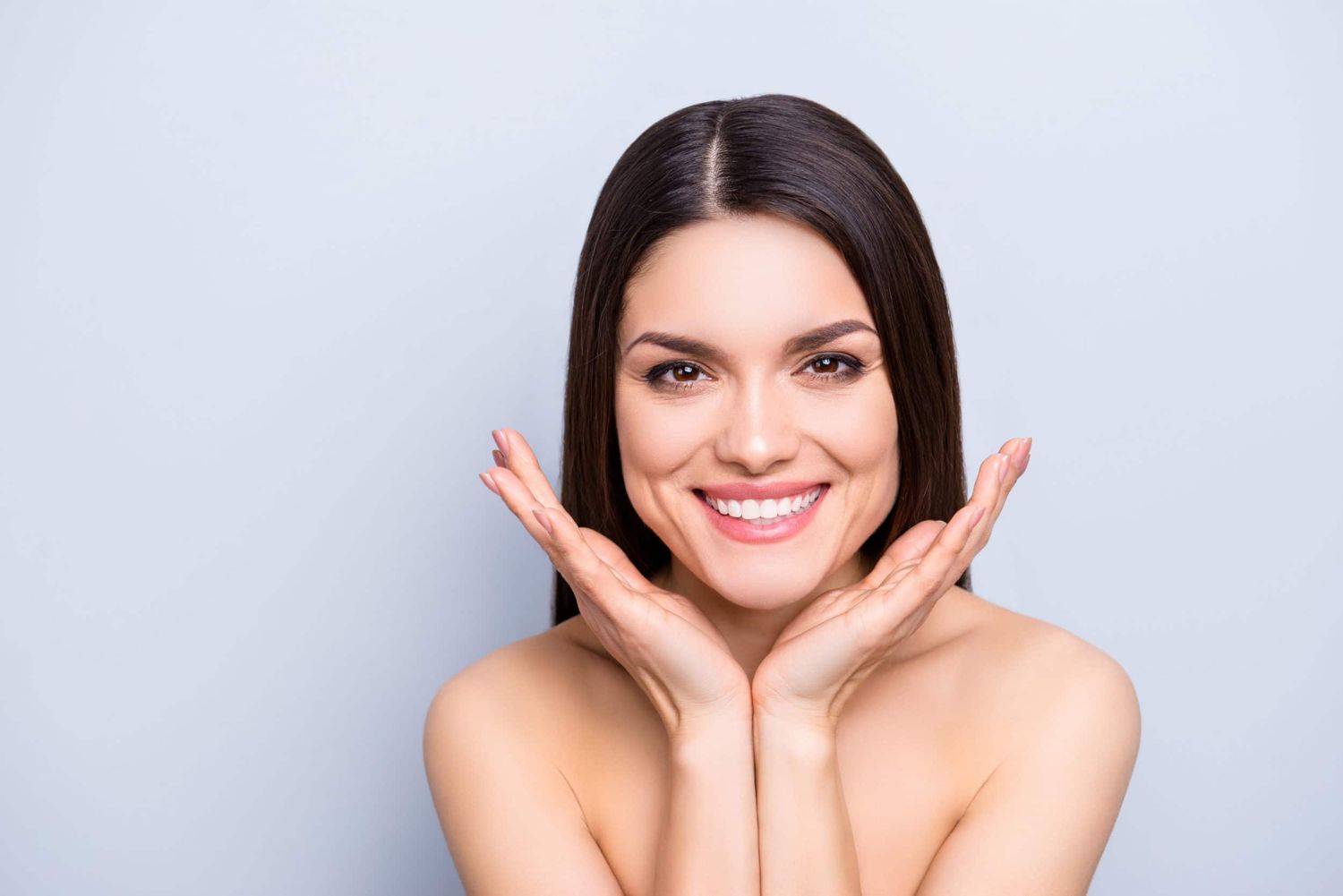 Houston Med Spa model with long hair and hands on face.