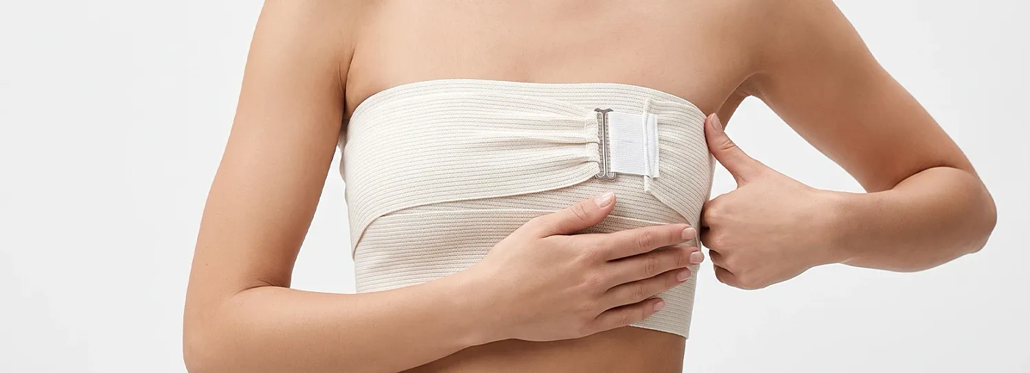 Model adjusting a strapless top with clasp.