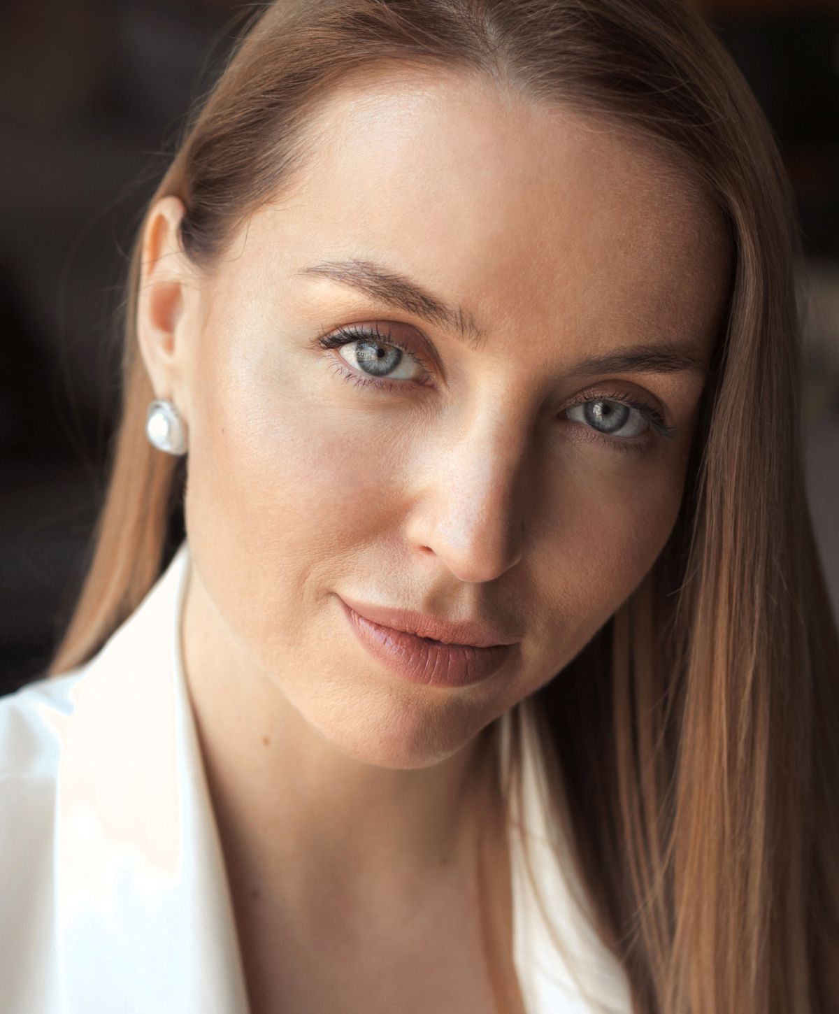 Close-up portrait of a woman with blue eyes.
