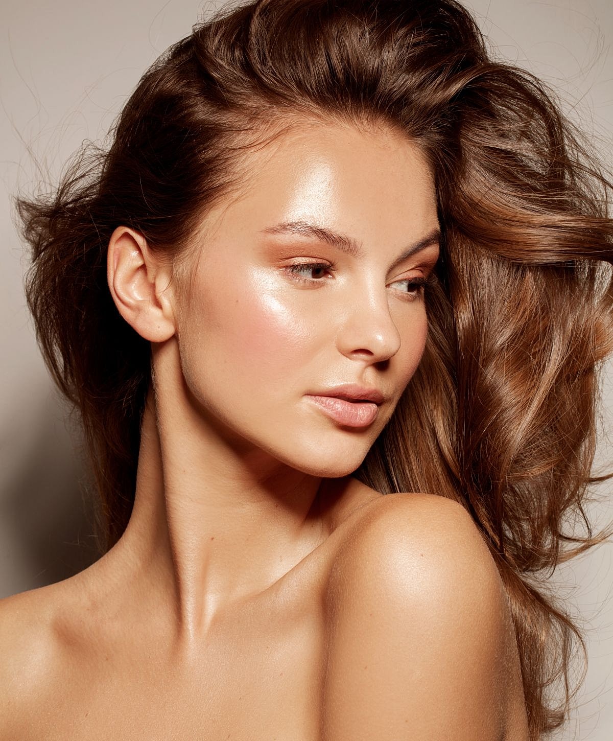 Model with glowing skin and flowing hair.