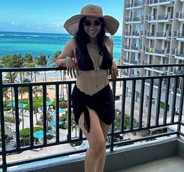 Woman in bikini enjoying beach view.