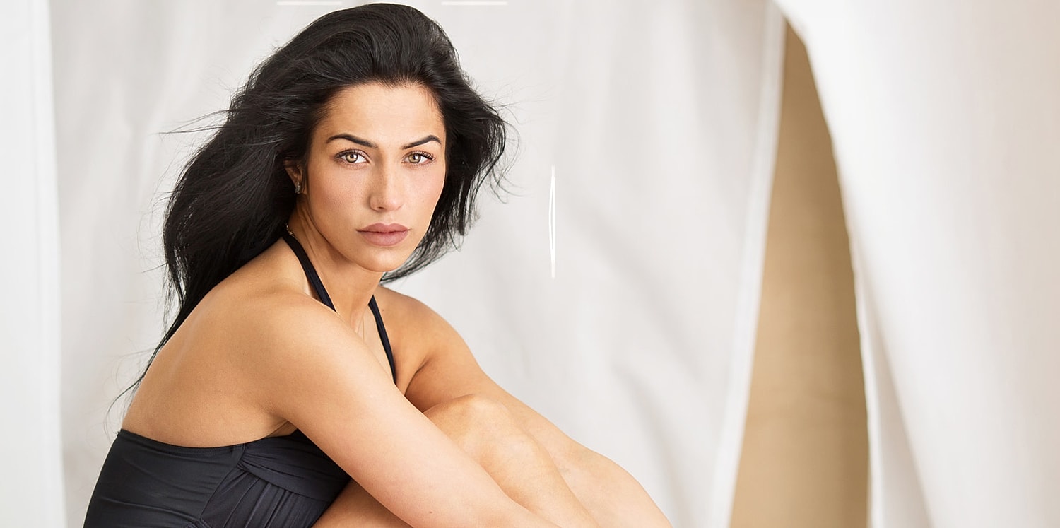Woman seated, looking directly at the camera.