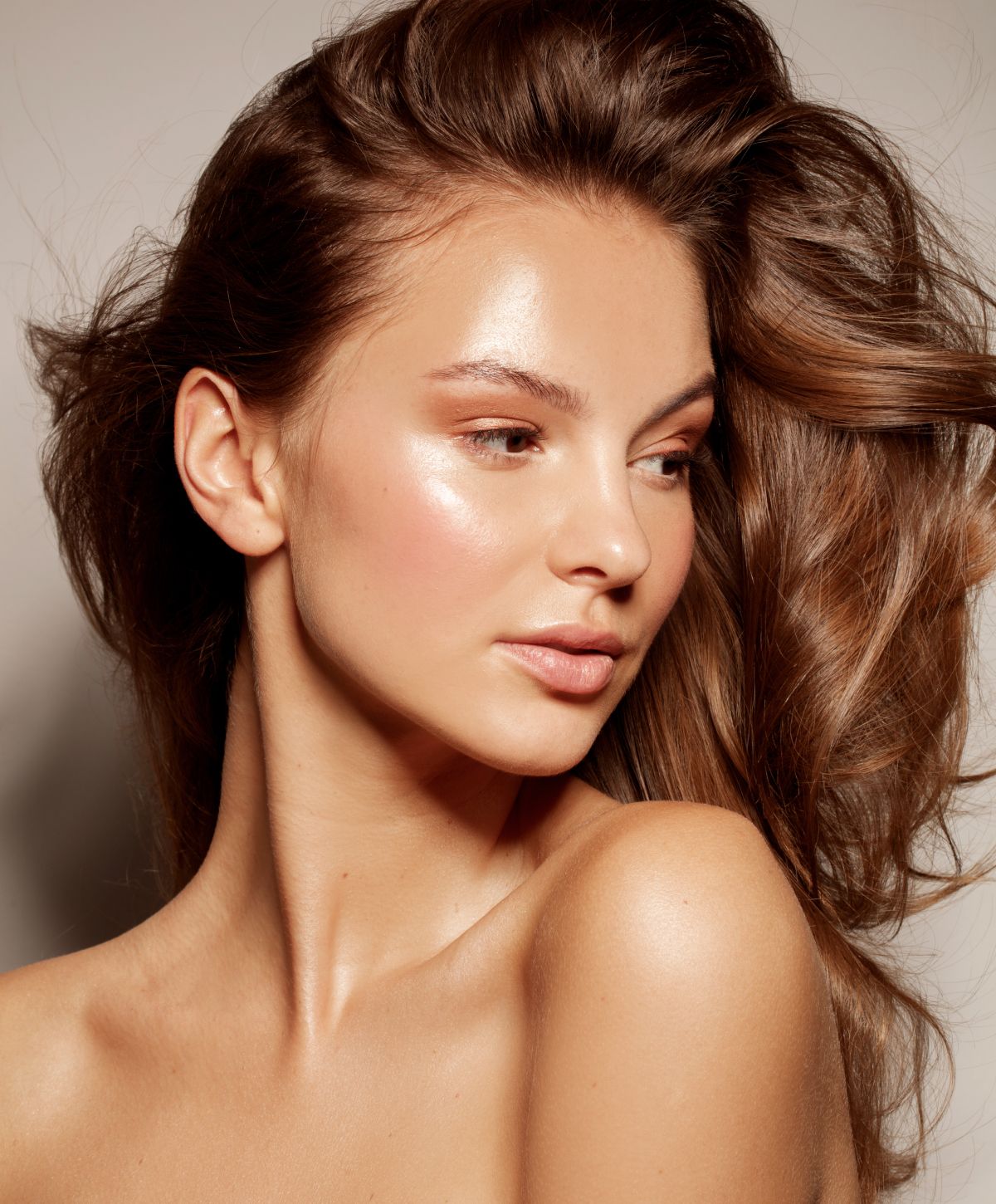 Close-up of a woman with glowing skin.