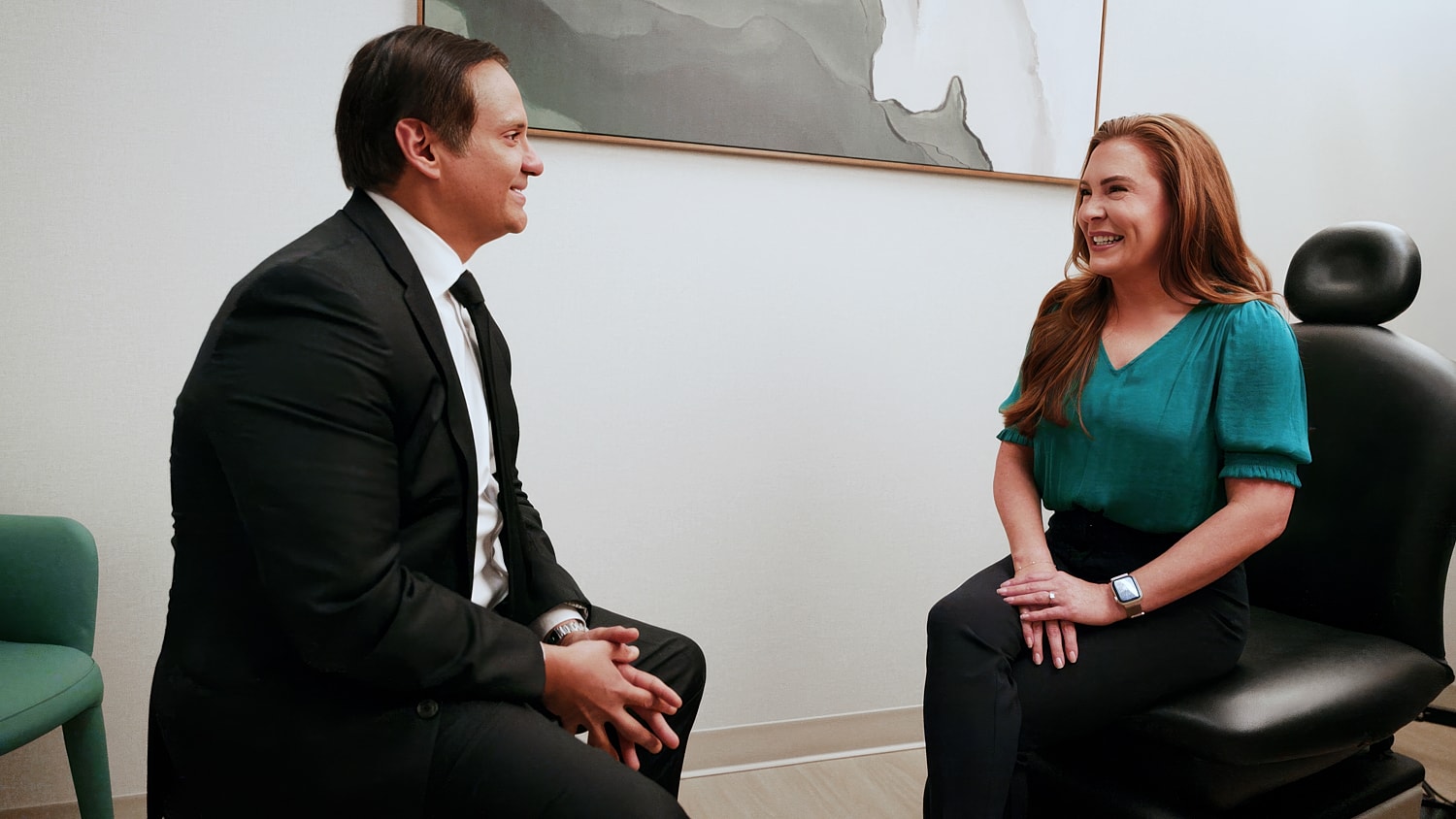 Patients consulting with healthcare professional in office.