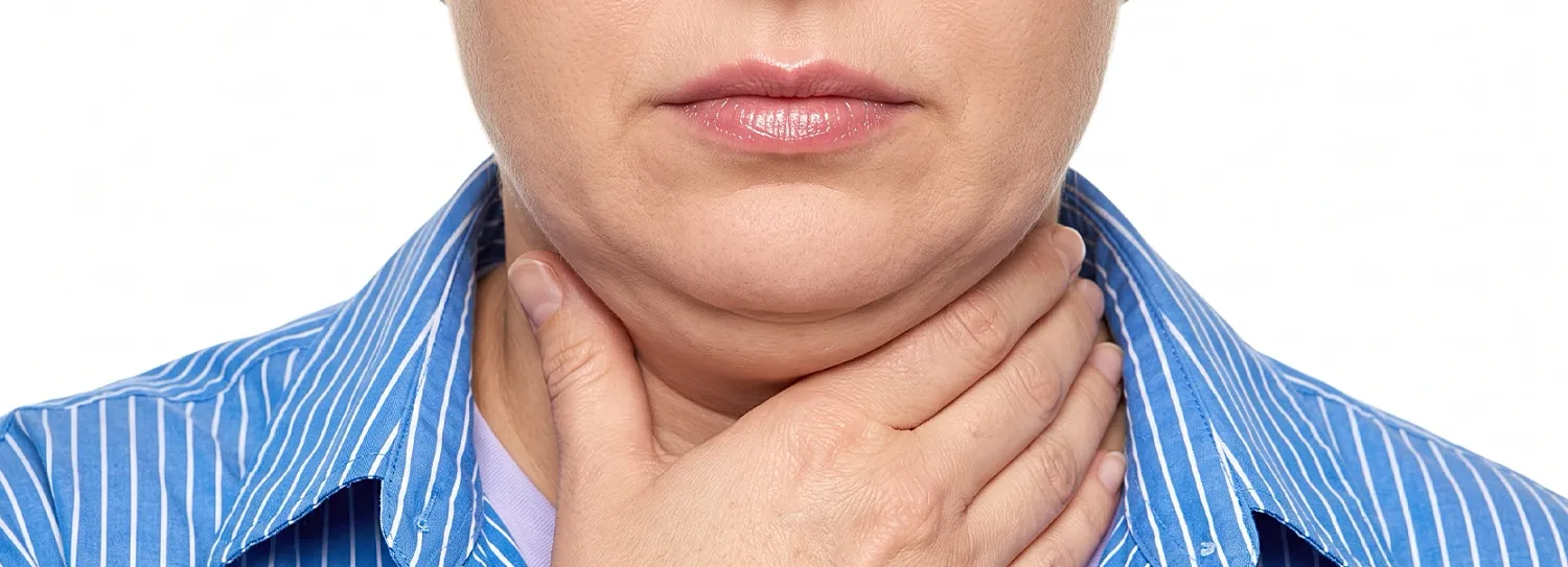 Person showing signs of throat discomfort or pain.