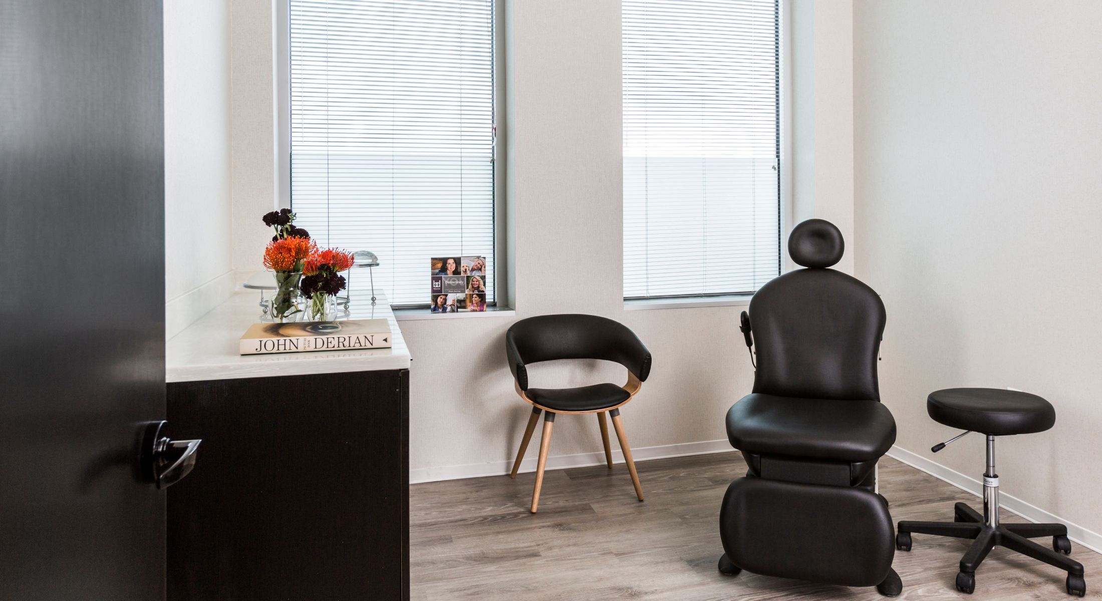 Modern medical office with black furniture and decor.