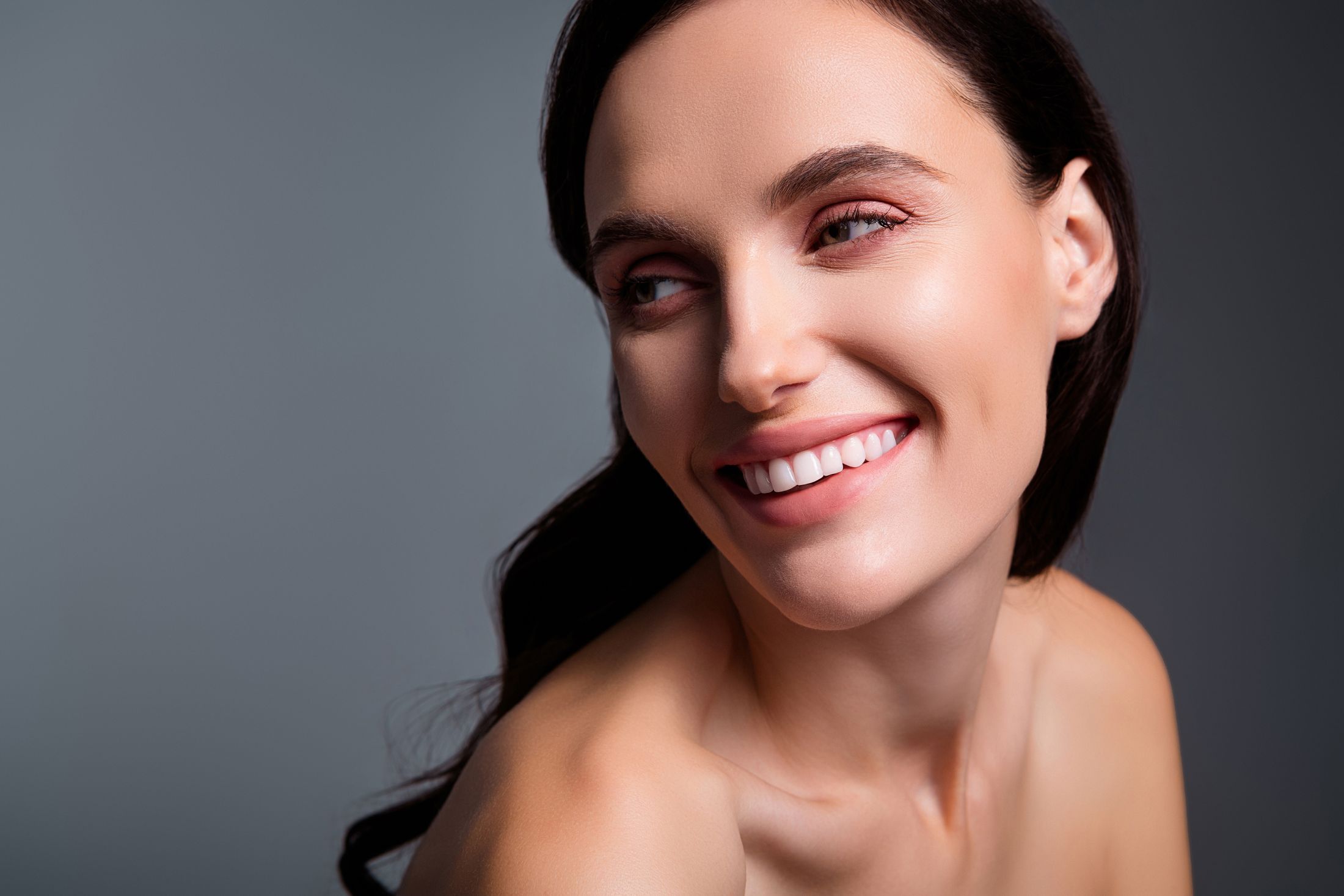 Smiling woman with beautiful skin and hair.