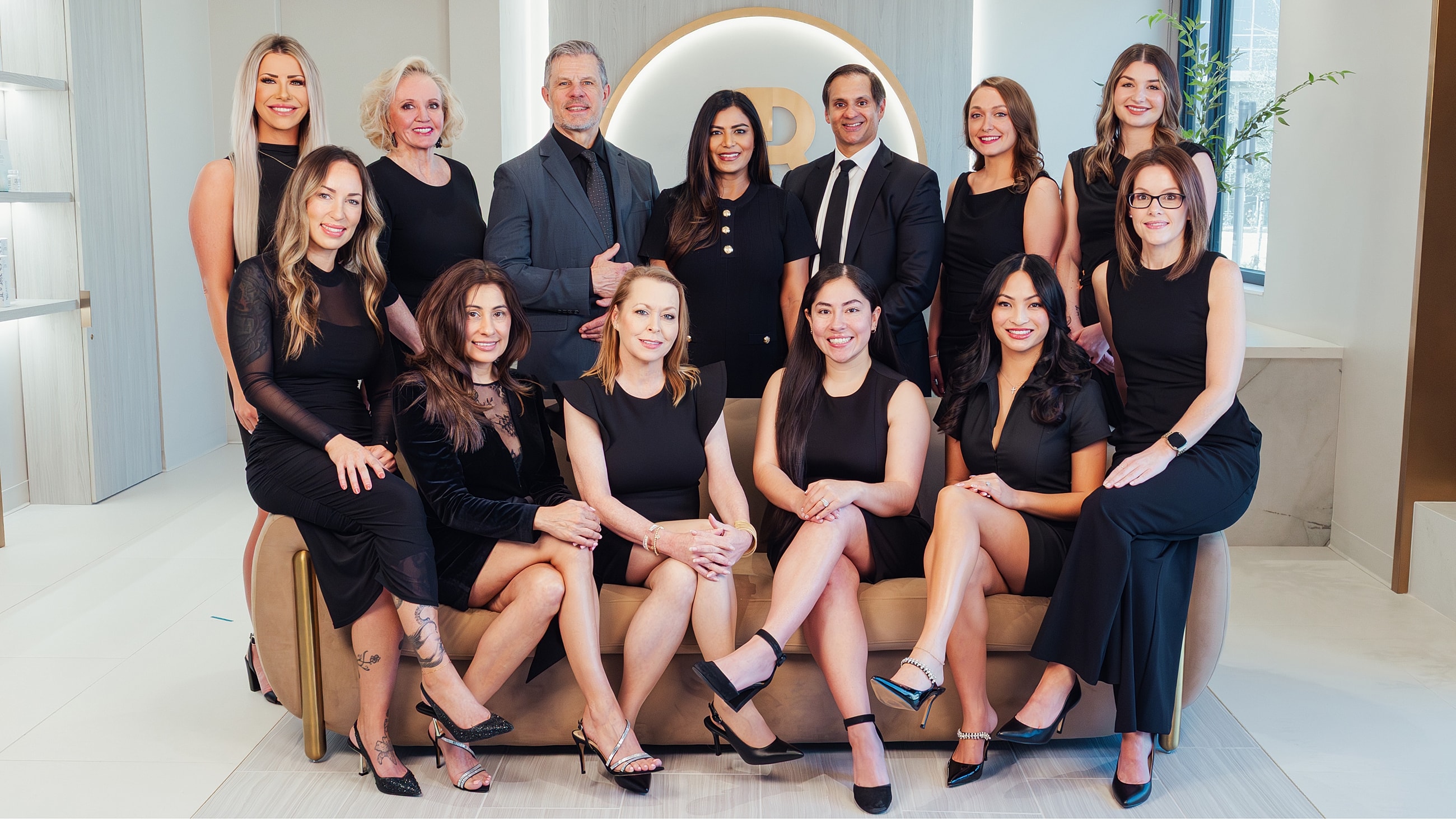 Professional group portrait in stylish black attire.