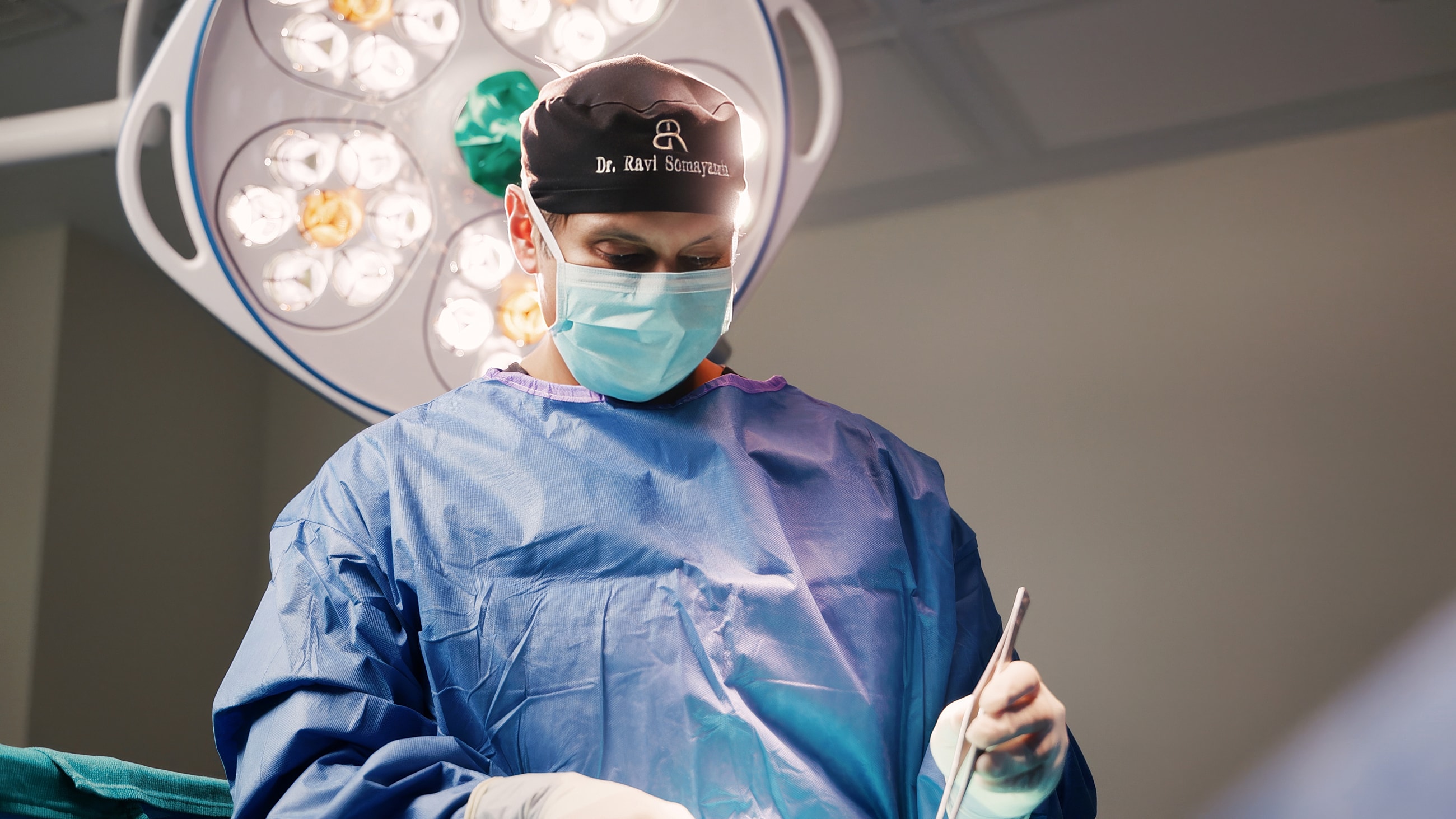 Surgeon focused on procedure in operating room.